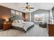 Spacious main bedroom with large bed, ceiling fan, and window seat at 8939 Devinney Ct, Arvada, CO 80005