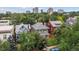 Aerial view of homes surrounded by trees and an urban skyline in the distance at 1352 N Downing St, Denver, CO 80218