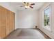 Bright bedroom featuring a ceiling fan, closet with bi-fold doors, and a large window at 1352 N Downing St, Denver, CO 80218