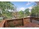 Wooden deck with lattice railing offers a private outdoor space surrounded by lush trees at 1352 N Downing St, Denver, CO 80218