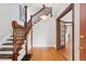Home entryway with hardwood floors, ornate staircase, traditional moldings, and warm lighting at 1352 N Downing St, Denver, CO 80218