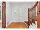 Inviting entryway featuring hardwood floors, a decorative front door, and elegant wooden banister at 1352 N Downing St, Denver, CO 80218