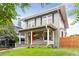 Quaint home showcasing a covered front porch with hanging plants and a lush green lawn at 1352 N Downing St, Denver, CO 80218