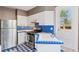 Quaint kitchen with white cabinetry, stainless steel appliances, and blue tiled accents at 1352 N Downing St, Denver, CO 80218