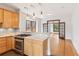 Bright kitchen features a breakfast bar, stainless steel appliances, and views into the living area at 1352 N Downing St, Denver, CO 80218