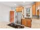 Well-lit kitchen featuring granite countertops, modern appliances, and ample cabinet space at 1352 N Downing St, Denver, CO 80218
