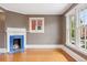 Inviting living room with hardwood floors, featuring a tiled fireplace and large bright windows at 1352 N Downing St, Denver, CO 80218