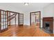 Spacious living room with hardwood floors, elegant trim, and a charming fireplace at 1352 N Downing St, Denver, CO 80218