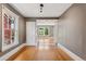 Neutral living room featuring hardwood floors, large windows, and a view through the door to another room at 1352 N Downing St, Denver, CO 80218