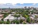 Aerial view of a neighborhood with diverse homes, mature trees, and a cityscape backdrop at 1352 N Downing St, Denver, CO 80218