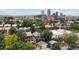 Picturesque neighborhood with a blend of homes, greenery, and a stunning city skyline as the backdrop at 1352 N Downing St, Denver, CO 80218