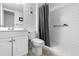 Bright bathroom with white fixtures, a shower with subway tile, and modern accessories at 13333 E Asbury Dr # 104, Aurora, CO 80014