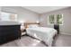 Bright bedroom featuring a wooden bed frame, wood-style flooring, and windows for natural light at 13333 E Asbury Dr # 104, Aurora, CO 80014