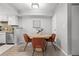 Bright dining area with a round table and modern chairs, adjacent to the kitchen and living area at 13333 E Asbury Dr # 104, Aurora, CO 80014