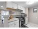 Modern kitchen with white cabinetry, stainless steel appliances, and a functional layout for cooking at 13333 E Asbury Dr # 104, Aurora, CO 80014