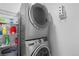 Efficient laundry room with stacked washer and dryer maximizing space and convenience at 13333 E Asbury Dr # 104, Aurora, CO 80014