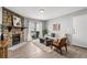 Inviting living room showcases a stone fireplace, comfortable seating, and a sliding glass door to the balcony at 13333 E Asbury Dr # 104, Aurora, CO 80014