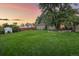 Large grassy backyard with a view of the house and surrounding area at 5450 Flower Ct, Arvada, CO 80002