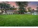 Large backyard with a grassy area, mature trees, and a shed at 5450 Flower Ct, Arvada, CO 80002