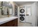 Convenient bathroom with stacked washer and dryer at 5450 Flower Ct, Arvada, CO 80002