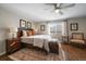 Main bedroom with hardwood floors, a king-size bed, and a comfy armchair at 5450 Flower Ct, Arvada, CO 80002