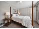 Bright bedroom with a wooden post bed, side table, and carpet flooring at 5450 Flower Ct, Arvada, CO 80002