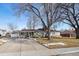 Ranch style home with a large yard and driveway at 5450 Flower Ct, Arvada, CO 80002