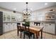 Kitchen nook with white cabinets, granite countertops, and a rustic wooden table at 5450 Flower Ct, Arvada, CO 80002