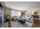 Bright and airy living room featuring hardwood floors and a stone fireplace at 5450 Flower Ct, Arvada, CO 80002