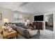 Comfortable living room with a gray sectional sofa and wooden media console at 5450 Flower Ct, Arvada, CO 80002