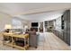 Spacious living room features a gray sectional sofa and built-in cabinetry at 5450 Flower Ct, Arvada, CO 80002