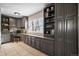 Home office with built-in gray cabinets and a corner desk at 5450 Flower Ct, Arvada, CO 80002