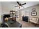 Home office featuring a large desk, shelving unit, and comfy armchair at 5450 Flower Ct, Arvada, CO 80002