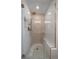 Large walk-in shower with patterned tile and built-in seat at 5450 Flower Ct, Arvada, CO 80002