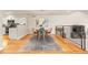Charming dining area adjacent to the kitchen features wood floors and modern chandelier at 2609 S Quebec St # 9, Denver, CO 80231