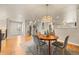 Bright dining area with wood floors, view of entry, staircase and adjacent kitchen at 2609 S Quebec St # 9, Denver, CO 80231