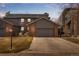 Townhome exterior with a gray color scheme, showing a two-car garage and driveway at 2609 S Quebec St # 9, Denver, CO 80231