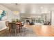 Open-concept living and dining area with fireplace and hardwood floors at 2609 S Quebec St # 9, Denver, CO 80231