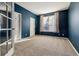 Bedroom with neutral carpet, a window with light-filtering shades, and a set of double doors at 6530 S Walden St, Aurora, CO 80016