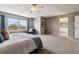 Spacious main bedroom features neutral colors, a ceiling fan and views to the outside at 6530 S Walden St, Aurora, CO 80016