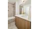 Modern bathroom featuring a sleek vanity, neutral tile, and a combined bathtub and shower at 1945 W 34Th Ave, Denver, CO 80211