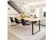 Modern dining area with a large table and seating for six, adjacent to the living room and staircase at 1945 W 34Th Ave, Denver, CO 80211