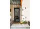Inviting front entrance with a modern door, brick accents, and colorful flowers, adding curb appeal at 1945 W 34Th Ave, Denver, CO 80211
