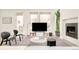 Modern living room featuring a fireplace, entertainment center, and ample natural light from large windows at 1945 W 34Th Ave, Denver, CO 80211
