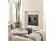 Cozy living room with a modern fireplace, comfortable seating, and a tall cactus near large windows at 1945 W 34Th Ave, Denver, CO 80211