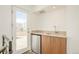 Rooftop wet bar with stainless steel mini-fridge and modern fixtures, leading to outdoor deck at 1945 W 34Th Ave, Denver, CO 80211