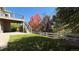 Landscaped backyard with deck, stairs, and wooden fence at 958 Bramblewood Dr, Castle Pines, CO 80108