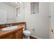 Powder room with wood vanity and tile flooring at 958 Bramblewood Dr, Castle Pines, CO 80108