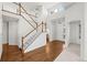 Two-story entryway with hardwood floors, staircase, and chandelier at 958 Bramblewood Dr, Castle Pines, CO 80108