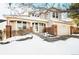 Two-story house with brick and siding exterior, attached garage, and snow-covered landscaping at 958 Bramblewood Dr, Castle Pines, CO 80108